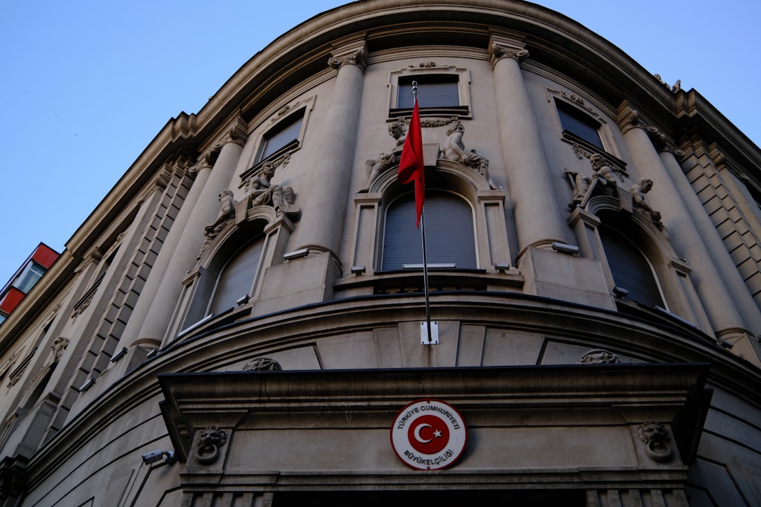 Ornate building facade with a turkish flag.