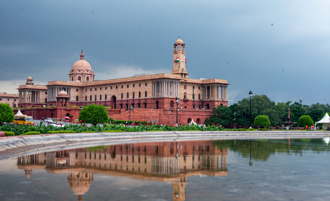 Grand building reflected in a calm pool of water