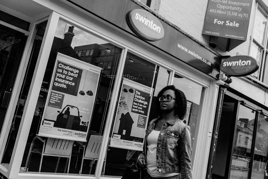 Woman walks past estate agent window