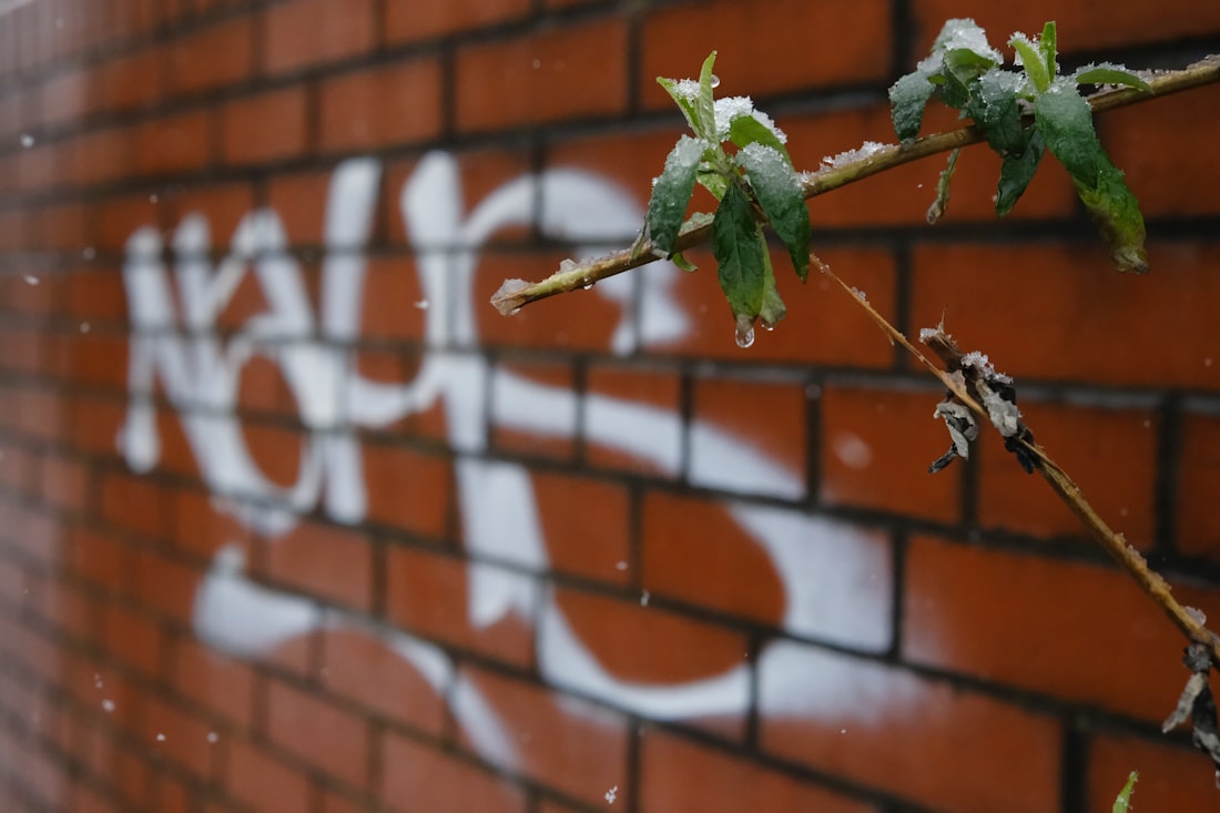 a red brick wall with graffiti on it