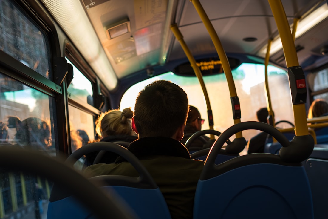 photo of man sitting inside bus