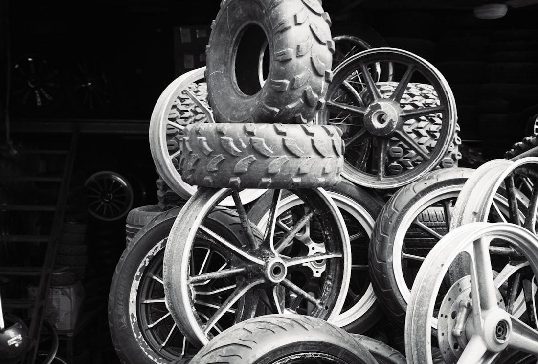 Pile of various tires and wheels stacked together